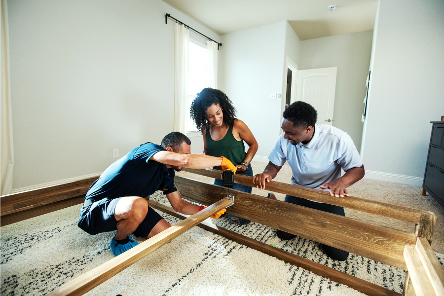 last mile delivery team assembling bed frame in customer's home